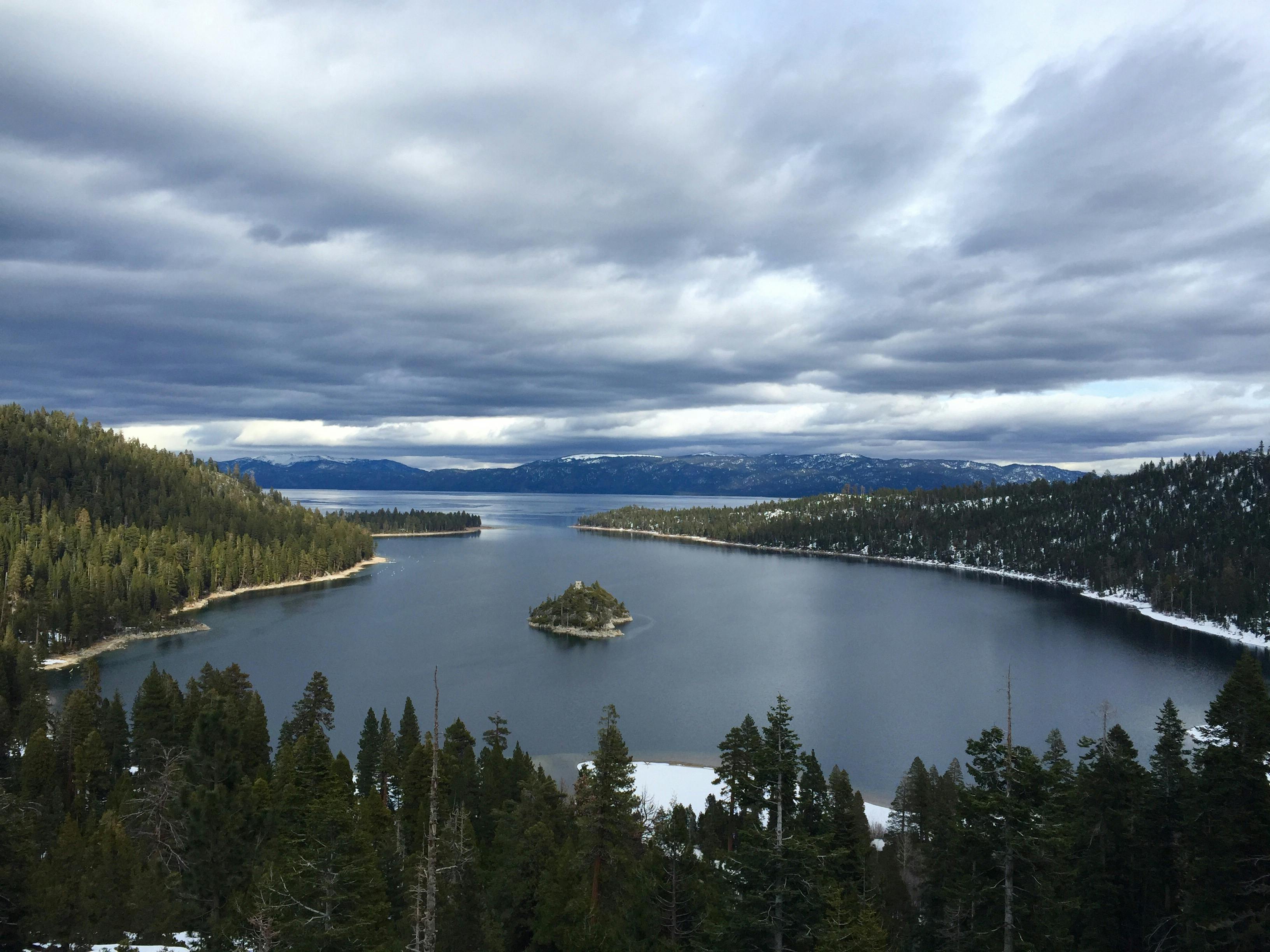 Person Showing Lake Under the White Clouds · Free Stock Photo